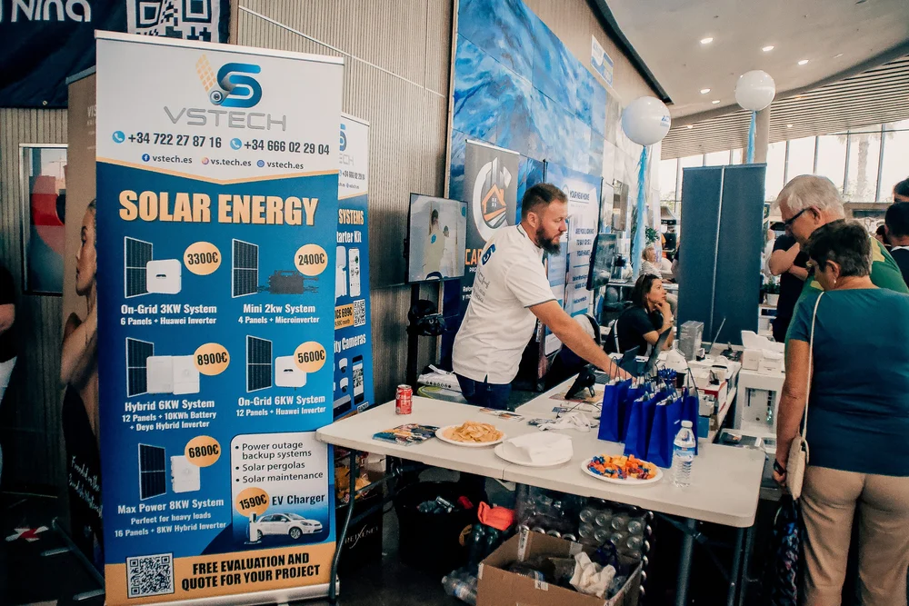 VSTECH stand showing solar packages, lithium batteries, and smart inverters