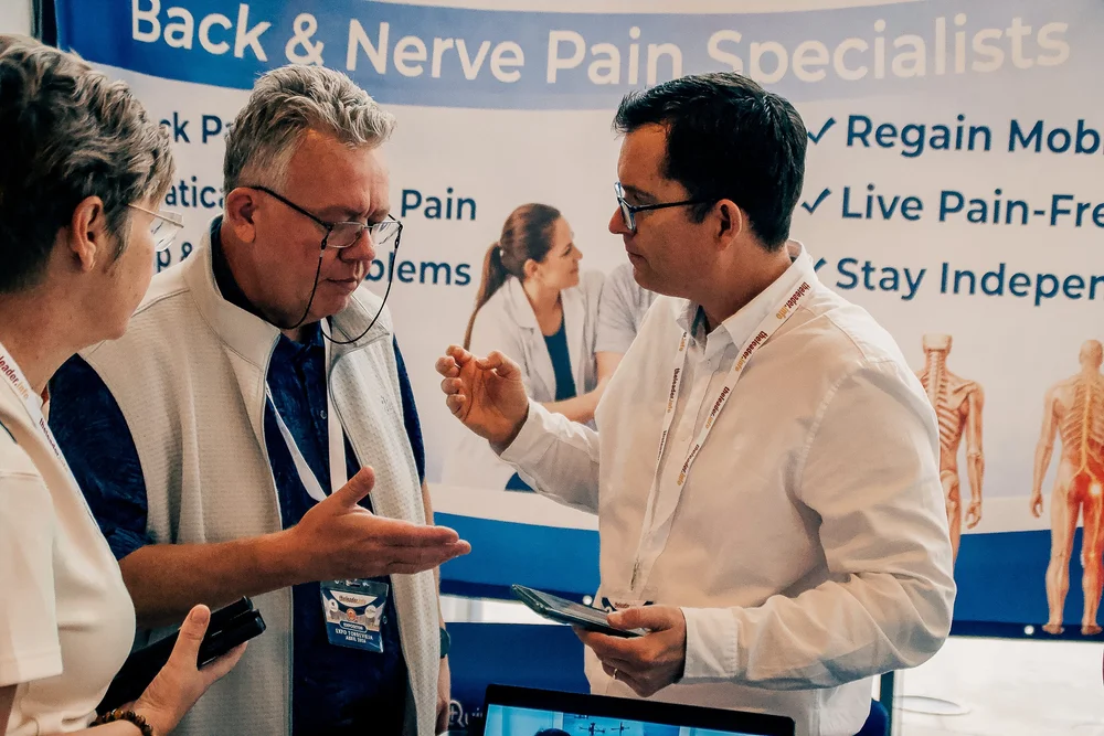 Back and nerve pain health specialist discussing treatment options with attendees