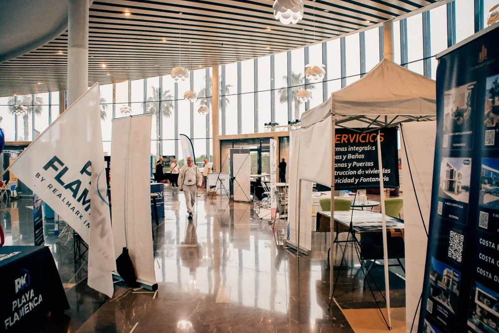 Spacious modern glass atrium with commercial stands at International Auditorium Torrevieja