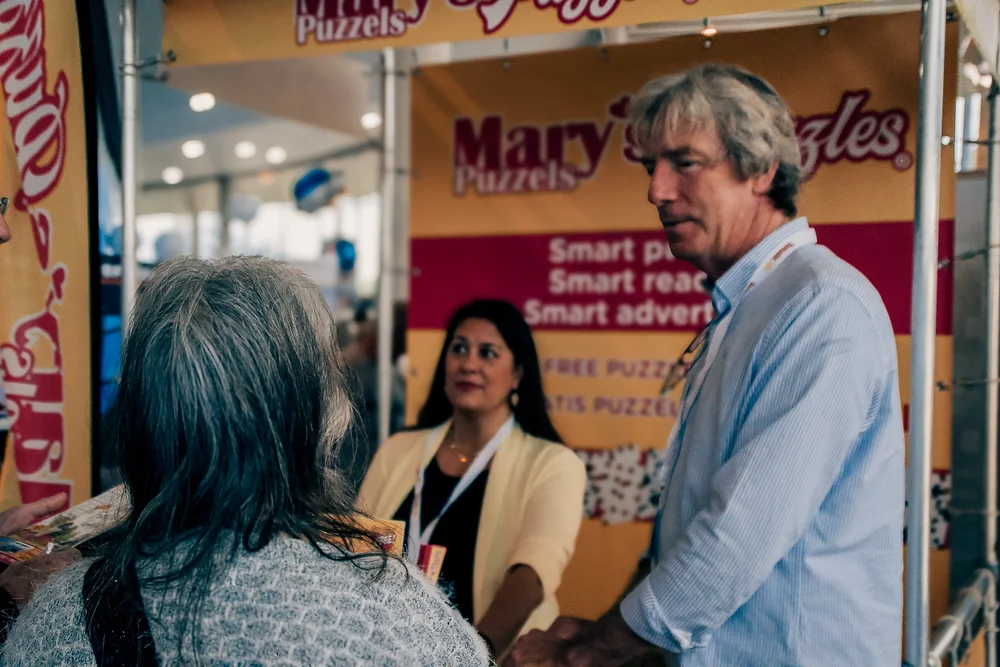 Marys Puzzels stand engaging attendees with interactive puzzles and games